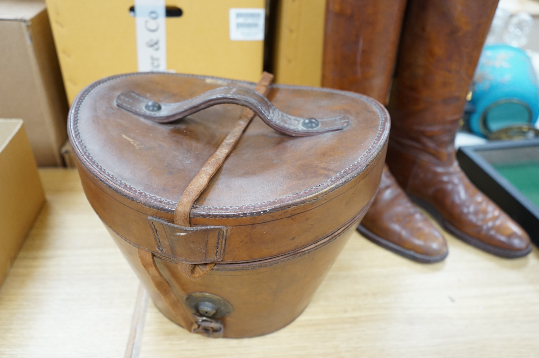 A pair of vintage leather riding boots and a leather cased top hat, ‘A.J. White, hatter to the Royal Family’. Condition - fair
